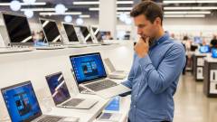 хлопець обирає ноутбук в магазині